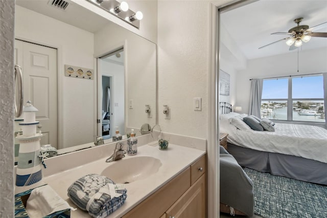 ensuite bathroom with visible vents, ceiling fan, vanity, and ensuite bathroom