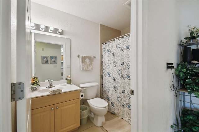 full bathroom with toilet, tile patterned flooring, a textured ceiling, and vanity