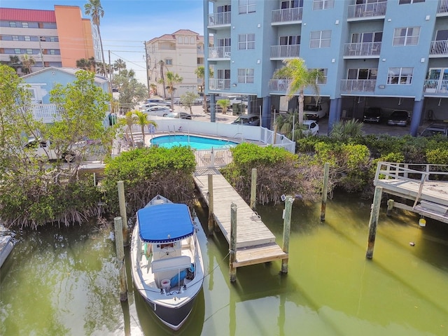 dock area featuring a water view and a community pool