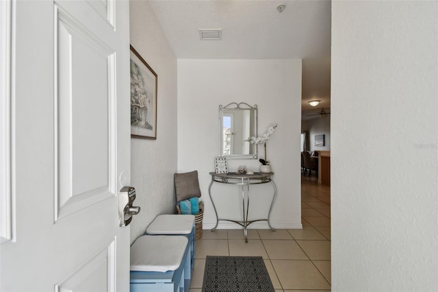 entryway with light tile patterned floors and visible vents