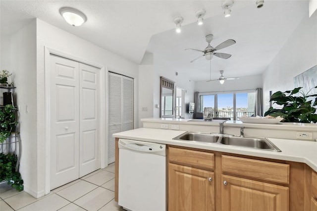 kitchen featuring light countertops, dishwasher, a sink, and light tile patterned flooring