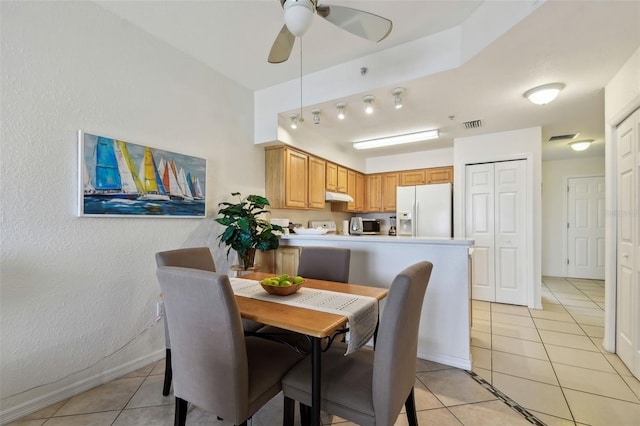 dining room with baseboards, light tile patterned flooring, visible vents, and a ceiling fan