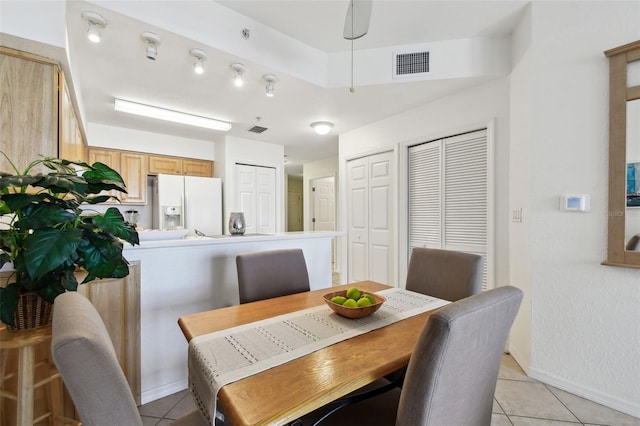 dining room featuring baseboards, visible vents, and light tile patterned flooring