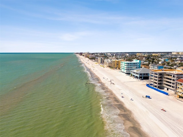 birds eye view of property with a water view and a view of the beach