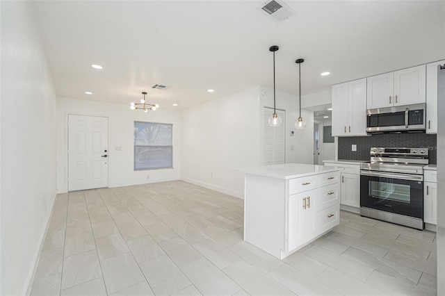 kitchen with visible vents, appliances with stainless steel finishes, light countertops, white cabinetry, and pendant lighting