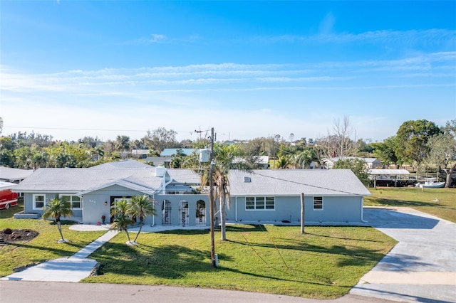 single story home with driveway and a front yard