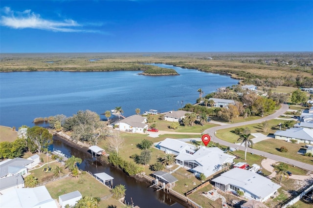 bird's eye view featuring a water view and a residential view