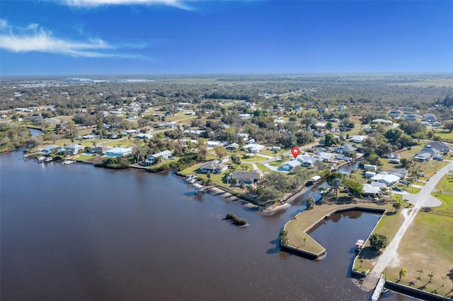 drone / aerial view with a water view and a residential view