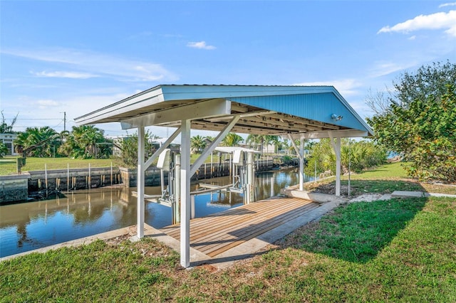 view of dock with a lawn, a water view, and boat lift