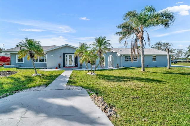 ranch-style home with french doors, a front lawn, and stucco siding