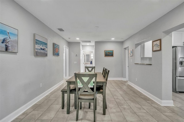 dining space with light tile patterned flooring, baseboards, visible vents, and recessed lighting