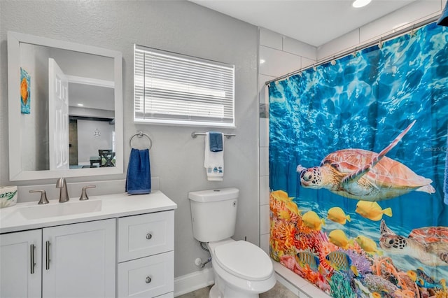 bathroom featuring curtained shower, baseboards, vanity, and toilet