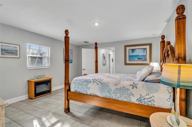 bedroom featuring light tile patterned floors, visible vents, and baseboards