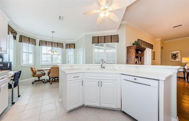 kitchen featuring light countertops, visible vents, white cabinets, white dishwasher, and a sink