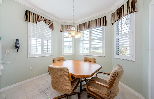 dining area featuring baseboards, a notable chandelier, and crown molding