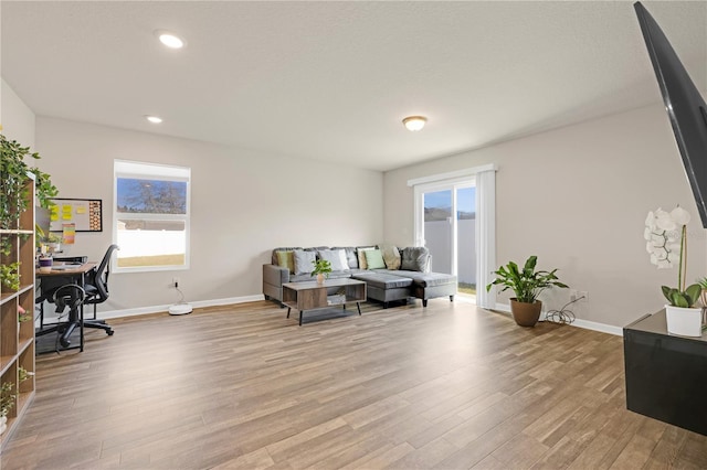 office space featuring light wood-style floors, recessed lighting, and baseboards