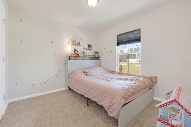 bedroom with light carpet and baseboards