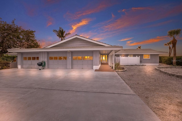 ranch-style house with a garage and concrete driveway