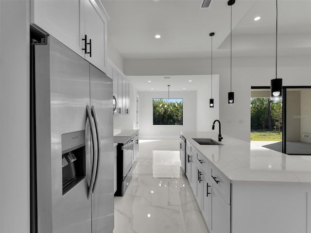 kitchen with marble finish floor, stainless steel appliances, recessed lighting, white cabinets, and a sink