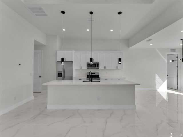 kitchen featuring appliances with stainless steel finishes, a spacious island, visible vents, and white cabinets