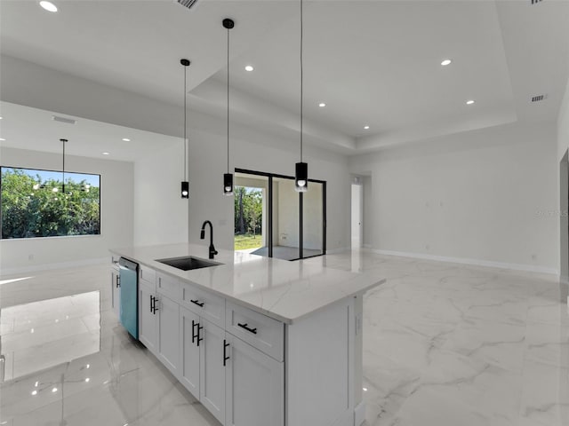 kitchen with a sink, open floor plan, dishwasher, plenty of natural light, and a raised ceiling