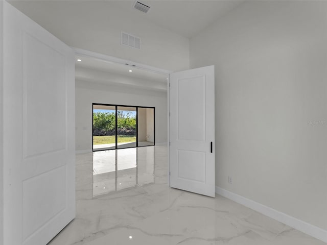 empty room featuring marble finish floor, recessed lighting, visible vents, and baseboards