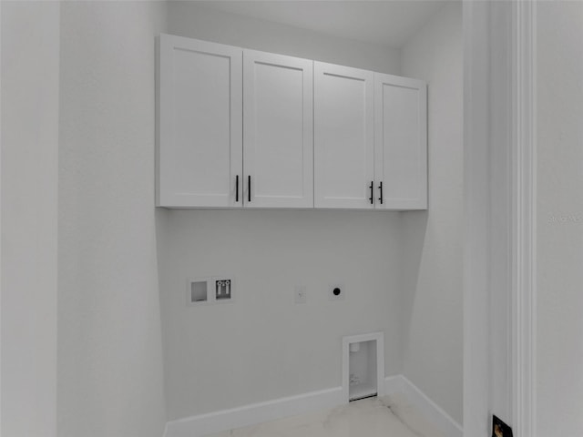 washroom with baseboards, washer hookup, cabinet space, and electric dryer hookup