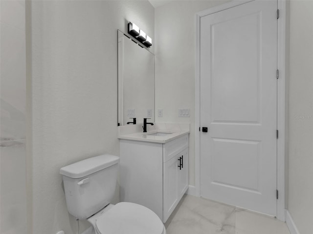 bathroom with marble finish floor, baseboards, vanity, and toilet