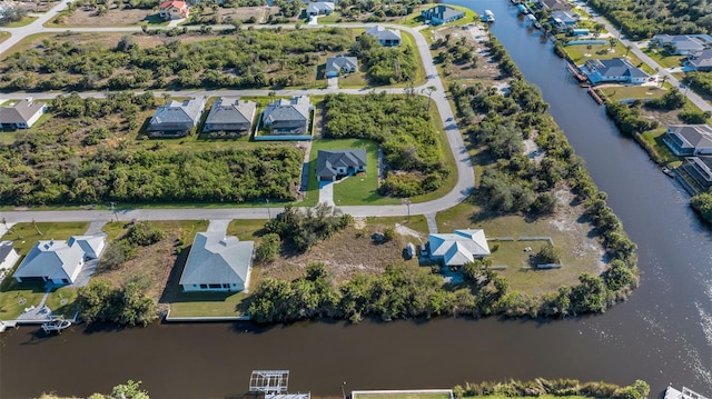 drone / aerial view featuring a water view and a residential view