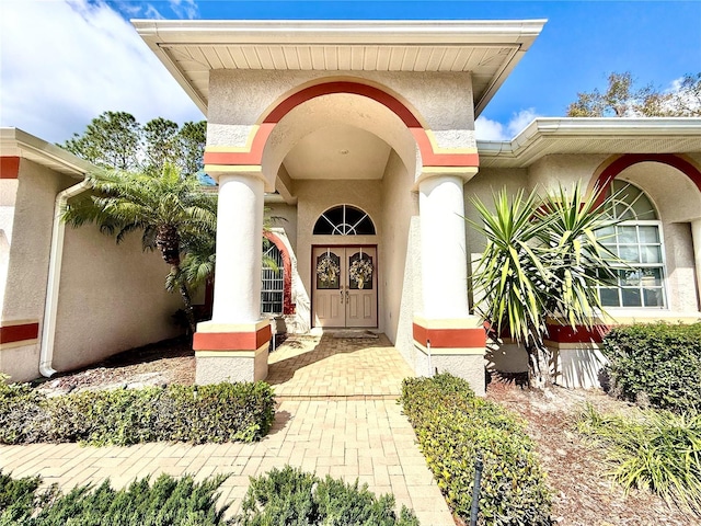 view of exterior entry with stucco siding