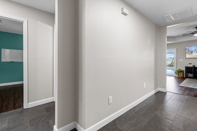 hall with visible vents and baseboards