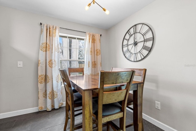 dining area with a chandelier and baseboards