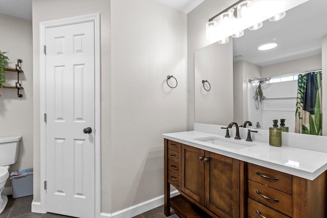 full bath with tile patterned flooring, vanity, toilet, and baseboards