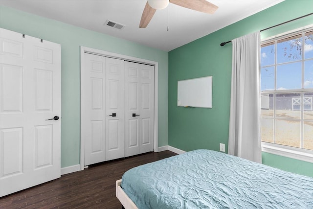 bedroom with visible vents, dark wood finished floors, baseboards, and multiple windows