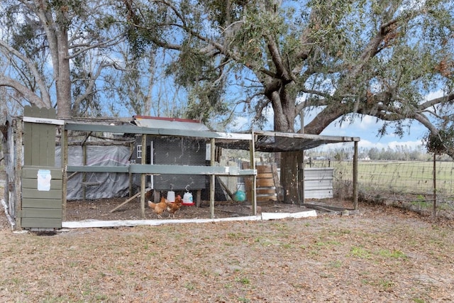 view of yard with an outbuilding, fence, and exterior structure