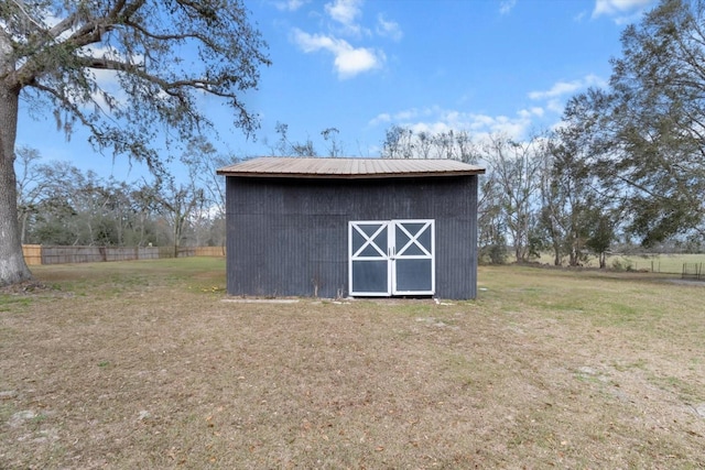 view of shed featuring fence