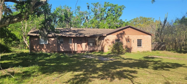 view of front of home with brick siding and a front yard