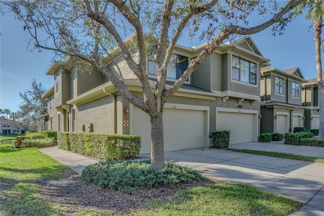 view of property exterior featuring a garage, driveway, a residential view, and stucco siding