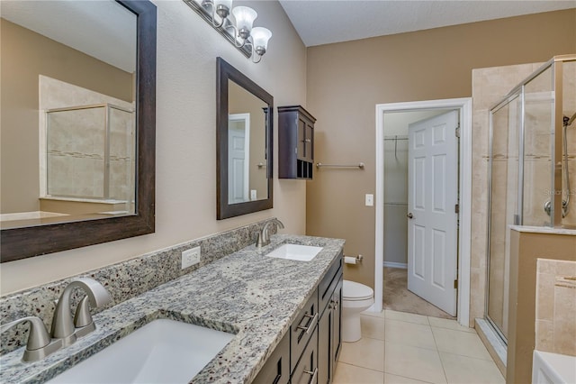 full bath featuring double vanity, tile patterned flooring, a shower stall, and a sink