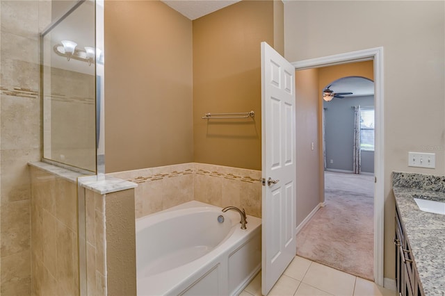 full bathroom with a garden tub, tile patterned floors, a tile shower, and vanity