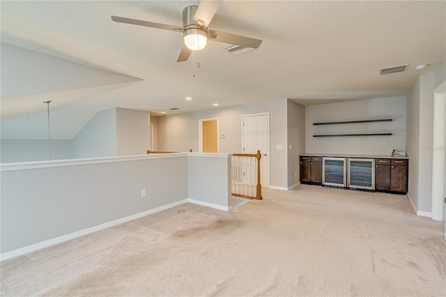 spare room featuring visible vents, light carpet, and baseboards