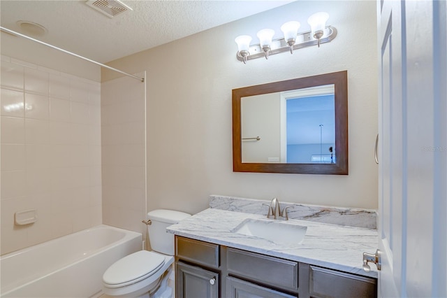 full bath featuring a textured ceiling, toilet, bathing tub / shower combination, vanity, and visible vents