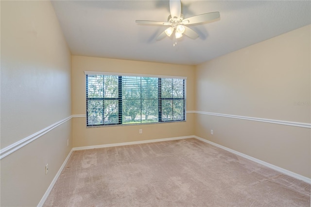 unfurnished room featuring a ceiling fan, carpet flooring, and baseboards