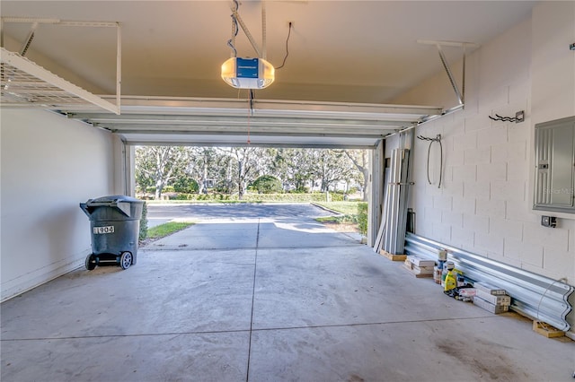 garage featuring electric panel and a garage door opener