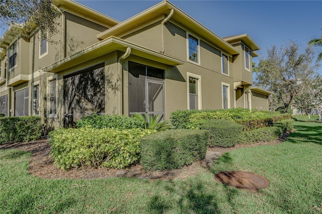 view of property exterior with a yard and stucco siding