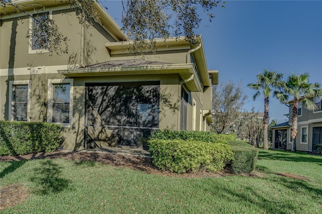 view of property exterior with a yard and stucco siding