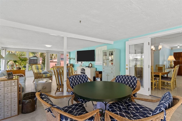 dining area featuring a chandelier and a textured ceiling