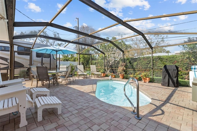 view of pool with glass enclosure, a fenced in pool, and a patio