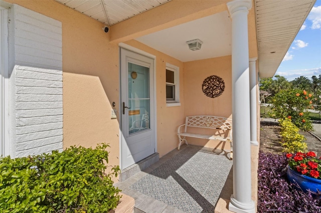 view of exterior entry with stucco siding