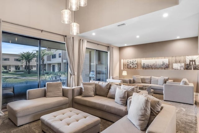 living room with carpet floors, recessed lighting, and visible vents